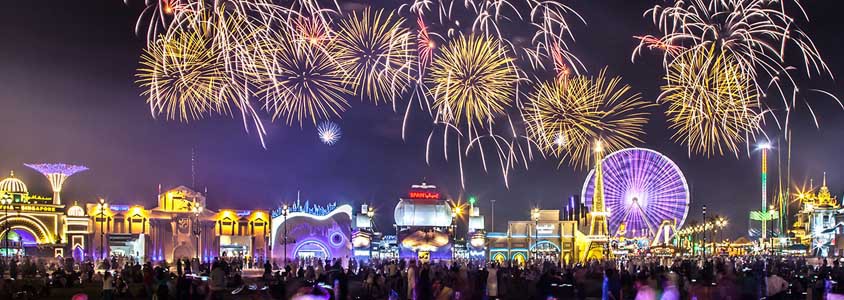 Night image of the Global Village Dubai with firework